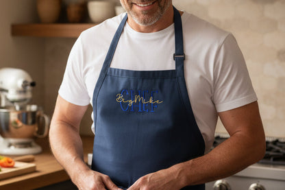 Man wearing a blue apron in a kitchen