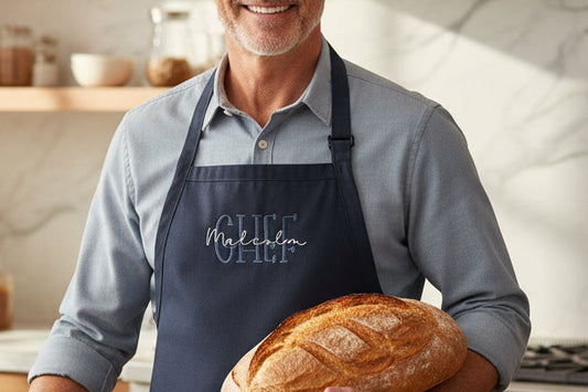 Man holding a loaf of bread in a kitchen